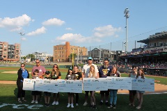 2024 Dayton Dragon Student MVP winners receive their oversized checks on the field