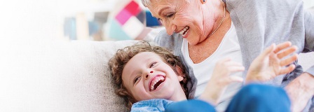 Grandfather smiling at laughing grandson