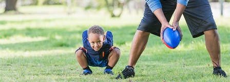 Father gets ready to hike the football to his young son