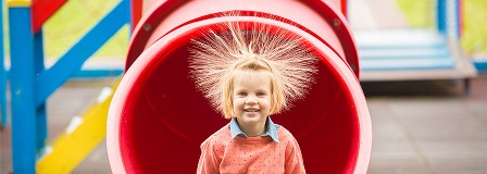 Little girl has major static hair after coming through plastic tube slide