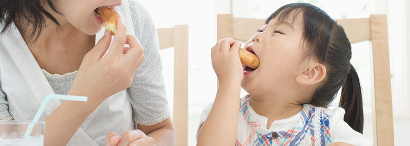 Mom and daughter share a donut