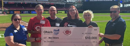 Skiera family accept their $10,000 Reds College Savings Grand Slam college savings award