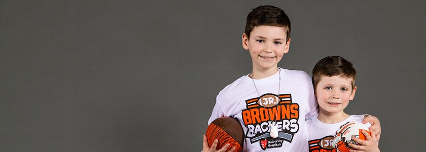 Two brothers wearing Jr. Brown Backers Club t-shirts