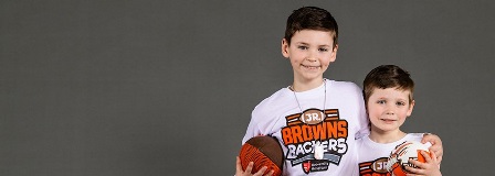 Two brothers wearing Jr. Brown Backers Club t-shirts