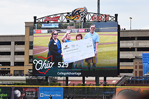 RubberDucks Most Improved Student winner and grandparentshold oversized check