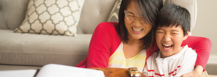 Mom hugs laughing son